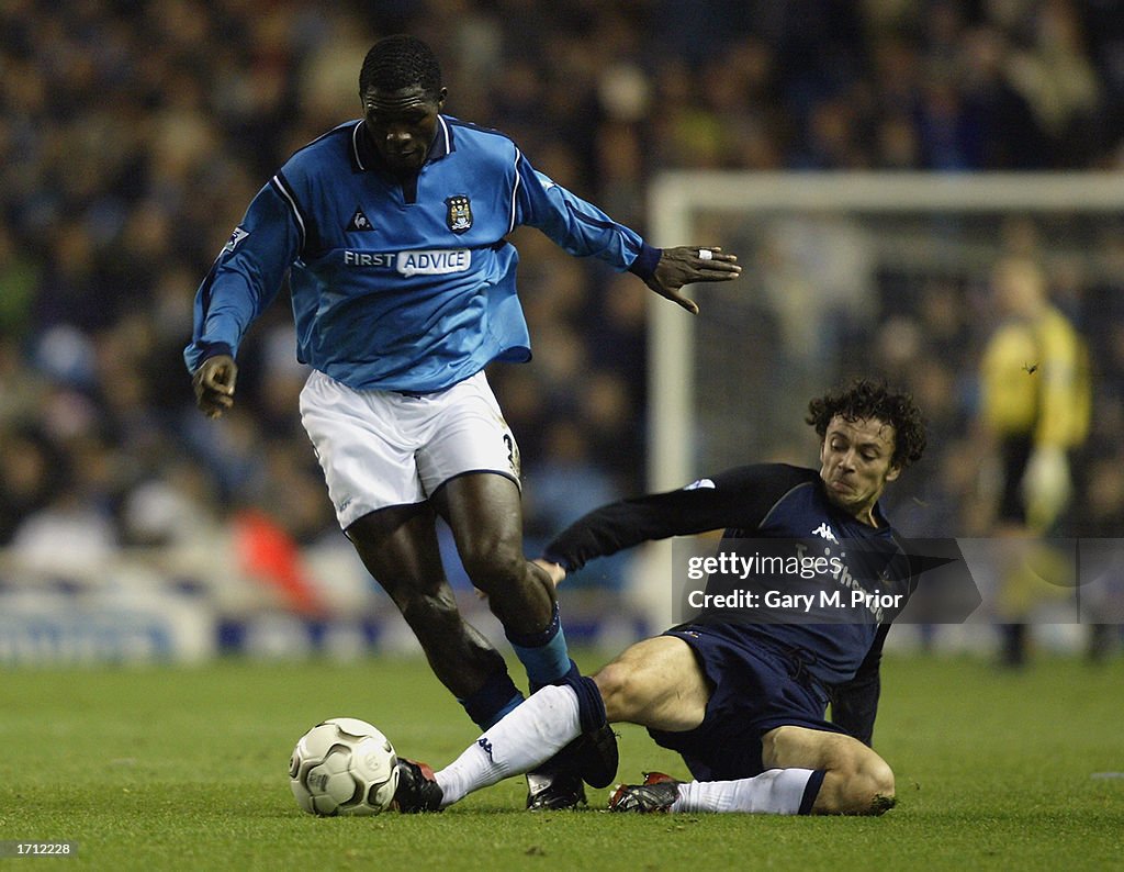 Marc Vivien Foe of Manchester City and Simon Davies of Tottenham Hotspur