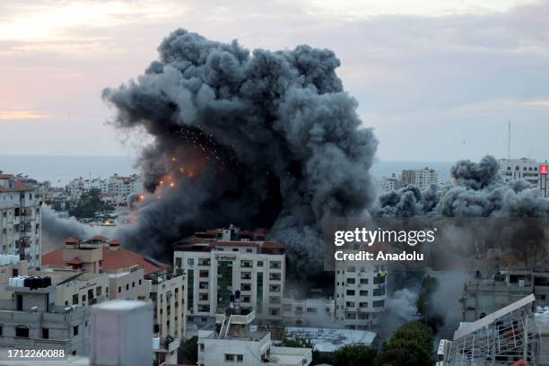 Smoke and flames rise after Israeli air forces targeting a shopping center in Gaza Strip, Gaza on October 07, 2023. Declaring a "state of readiness"...