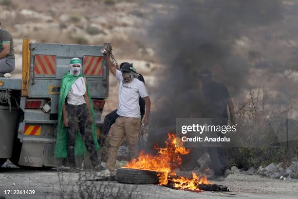 Palestinians burn car tires and block roads as they clash with Israeli forces in Beit El district of Ramallah, West Bank on October 07, 2023.