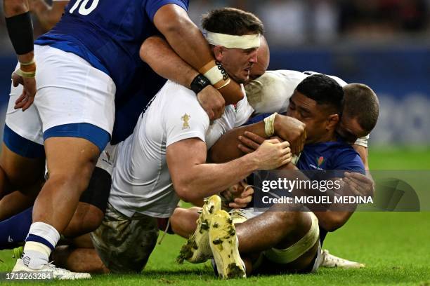 England's flanker Tom Curry competes in a ruck during the France 2023 Rugby World Cup Pool D match between England and Samoa at the Stade...