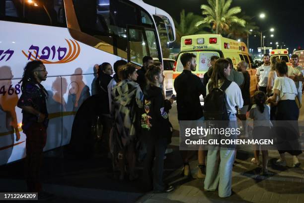 Graphic content / Residents of the southern Israeli city of Netivot bordering the Gaza Strip wait near a bus before being evacuated to central Israel...