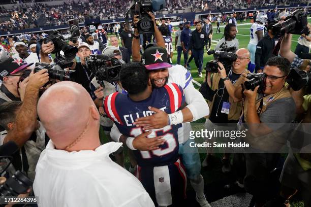 Dak Prescott of the Dallas Cowboys hugs Ezekiel Elliott of the New England Patriots after Dallas' 38-3 win at AT&T Stadium on October 01, 2023 in...