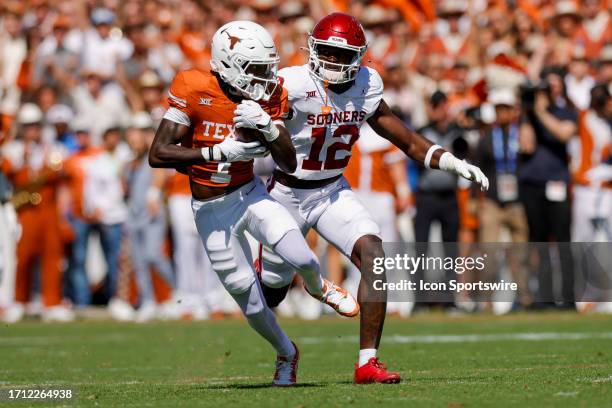 Texas Longhorns wide receiver Xavier Worthy catches a pass over Oklahoma Sooners defensive back Key Lawrence during the game between the Texas...