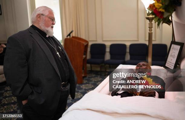 Reverend Robert Whitmer visits the body of 'Stoneman Willie' , during his funeral service in Reading, Pennsylvania, on October 7, 2023. "Stoneman...