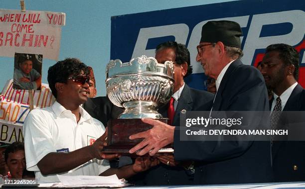 Nepalese Prime Minister Girija Prasad Koirala gives the trophy of Asian Cricket Council to Bangladesh Captain Amin-UL Islam in Kathmandu 13 October....