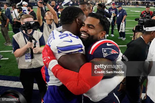 DeMarcus Lawrence of the Dallas Cowboys hugs Ezekiel Elliott of the New England Patriots after Dallas' 38-3 win at AT&T Stadium on October 01, 2023...