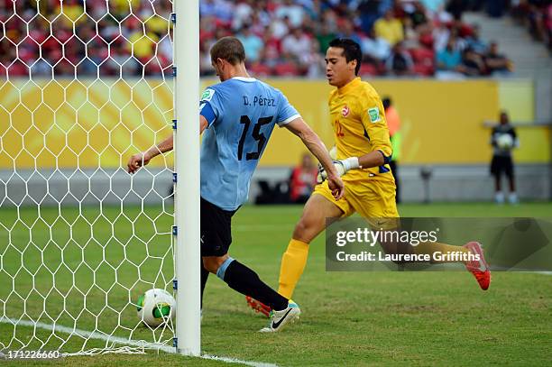 Diego Perez of Uruguay scores a goal in the 27th minute against Gilbert Meriel of Tahiti during the FIFA Confederations Cup Brazil 2013 Group B match...