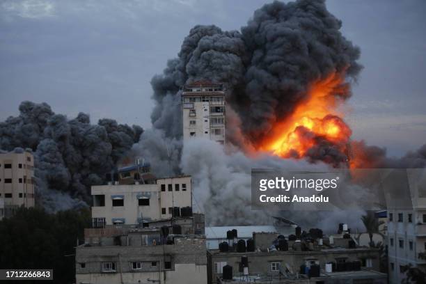 Smoke and flame rise after Israeli air forces targeting a shopping center in Gaza Strip, Gaza on October 07, 2023. Israeli airstrikes on Gaza Strip...