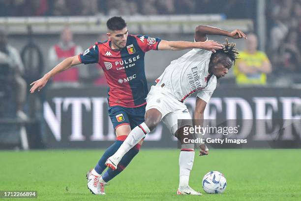 Johan Vasquez of Genoa and Samuel Chukwueze of Milan vie for the ball during the Serie A TIM match between Genoa CFC and AC Milan at Stadio Luigi...