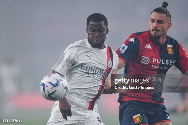 Yunus Musah of Milan and Radu Dragusin of Genoa vie for the ball during the Serie A TIM match between Genoa CFC and AC Milan at Stadio Luigi Ferraris...