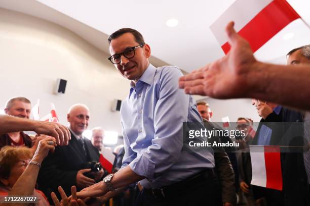 Polish Prime Minister Mateusz Morawiecki greets supporters during the ruling 'Law and Justice' party pre-election rally in Myslowice, Poland on...