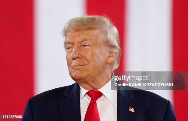 Former US President and 2024 Presidential hopeful Donald Trump arrives to speak during a Team Trump Iowa Commit to Caucus event at the National...