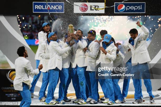 Shikhar Dhawan of India lifts the trophy as he celebrates victory with team mates during the ICC Champions Trophy Final between England and India at...