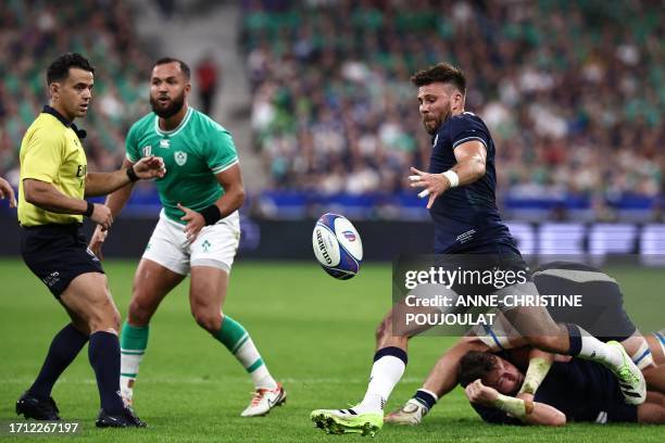 Scotland's scrum-half Ali Price clears the ball out of a ruck during the France 2023 Rugby World Cup Pool B match between Ireland and Scotland at the...