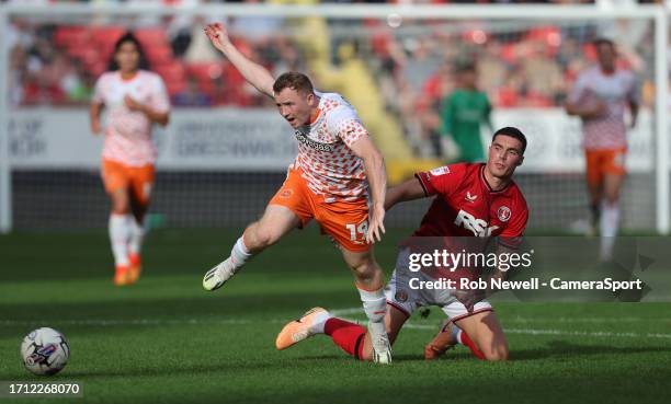 Blackpool's Shayne Lavery is challenged by Charlton Athletic's Lloyd Jones during the Sky Bet League One match between Charlton Athletic and...