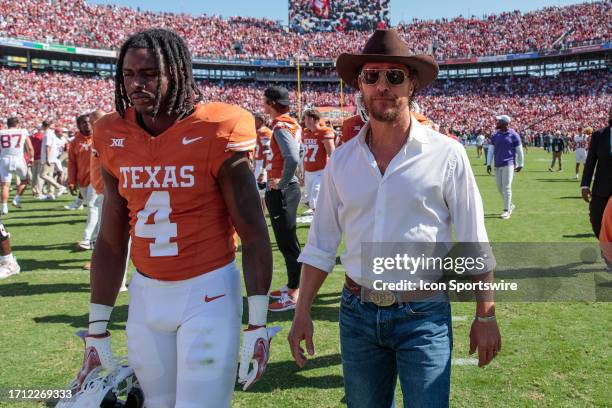 Actor Mathew McConaughey walks off field with Texas Longhorns defensive back Austin Jordan after the game against the Oklahoma Sooners on October...