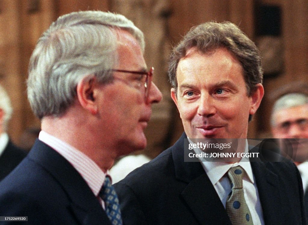 British Prime Minister Tony Blair walks with former Prime Minister