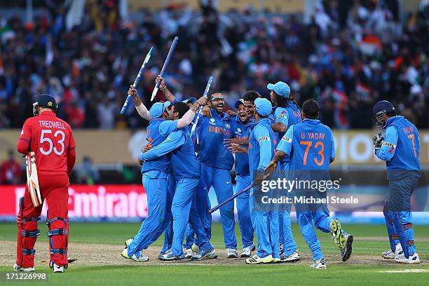 James Tredwell of England cuts a lonely figure as India players celebrate their 5 run victory during the ICC Champions Trophy Final match between...