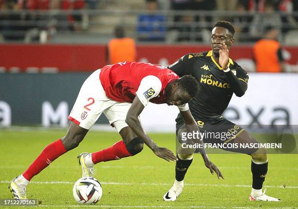 Reims' defender Joseph Okumu fights for the ball with Monaco's forward Folarin Balogun during the French L1 football match between Stade de Reims and...