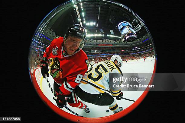 Marian Hossa of the Chicago Blackhawks attempts to get past Johnny Boychuk of the Boston Bruins in Game Five of the 2013 NHL Stanley Cup Final at...