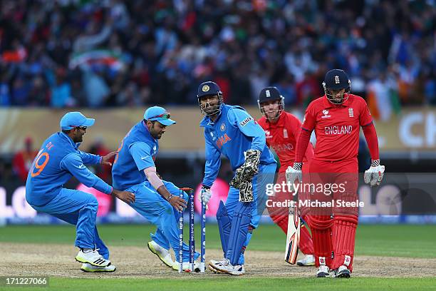 James Tredwell of England cuts a lonely figure as India players Dinesh Karthik Suresh Raina and MS Dhoni celebrate their 5 run victory during the ICC...