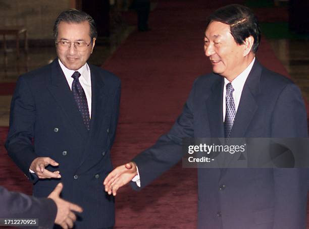 Malaysian Prime Minister Mahathir Mohamad introduces his delegation to Chinese Premier Zhu Rongji prior to a meeting at the Great Hall of the People...
