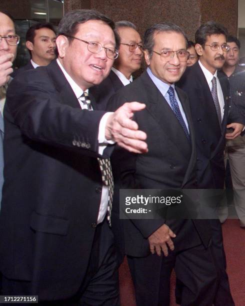 Malaysian Prime Minister Mahathir Mohamad is ushered by the chairman of the Malaysian consortium the Lion Group, William Cheng , as Mahathir arrived...