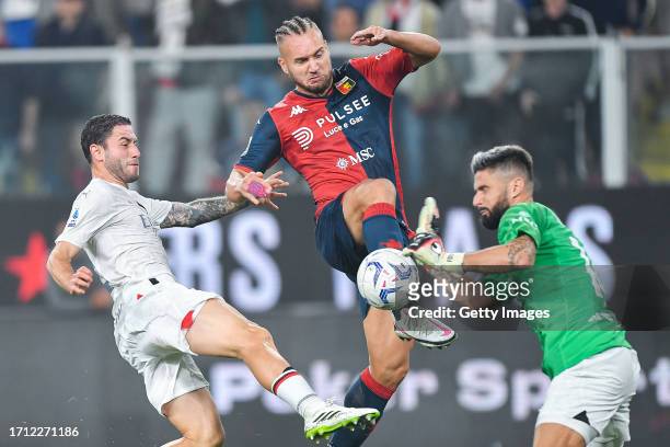 Davide Calabria of Milan, George Puscas of Genoa and Olivier Giroud of Milan vie for the ball during the Serie A TIM match between Genoa CFC and AC...