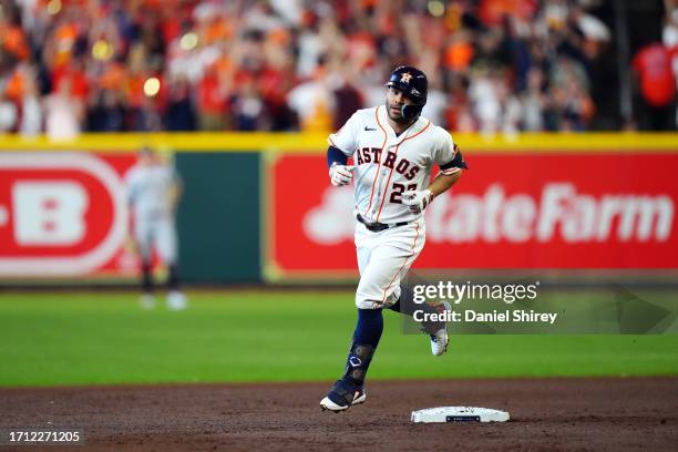 Jose Altuve of the Houston Astros rounds the bases after hitting a solo home run in the first inning during Game 1 of the Division Series between the...