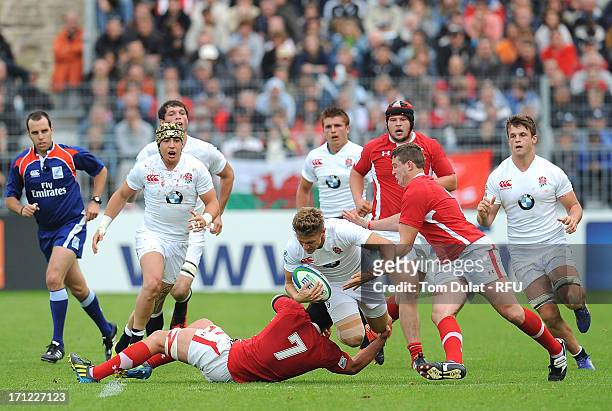 Callum Braley of England is tackled by Ellis Jenkins and Elliot Dee of Wales during the IRB Junior World Championship Final match between England U20...