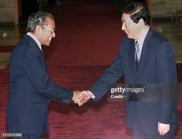 Chinese Premier Zhu Rongji shakes hands with Malaysian Prime Minister Mahathir Mohamad prior to a meeting at the Great Hall of the People in Beijing...