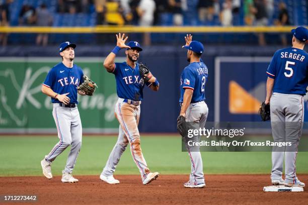 Leody Taveras and Marcus Semien of the Texas Rangers celebrate a victory over the Tampa Bay Rays after Game One of the Wild Card Series at Tropicana...