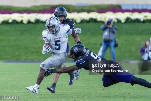 Howard Bison running back Eden James is grabbed by Northwestern Wildcats defensive back Devin Turner during the college football game between the...