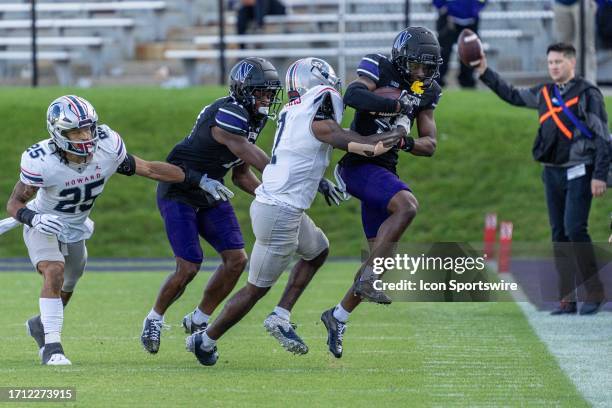 Northwestern Wildcats wide receiver Calvin Johnson II is grabbed by Howard Bison defensive back Ray Williams while Northwestern Wildcats wide...