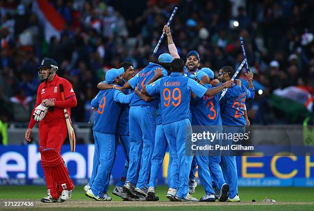 The India team celebrate as James Tredwell of England looks dejected after India won the ICC Champions Trophy Final match between England and India...