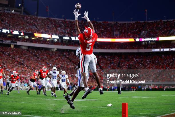 Rara Thomas of the Georgia Bulldogs makes a touchdown reception over Maxwell Hairston of the Kentucky Wildcats during the first quarter at Sanford...