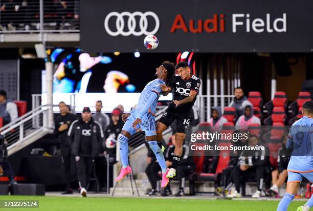 New York City FC forward Talles Magno and DC United defender Andy Najar go up for a header in front of an Audi field logo sign during the New York...