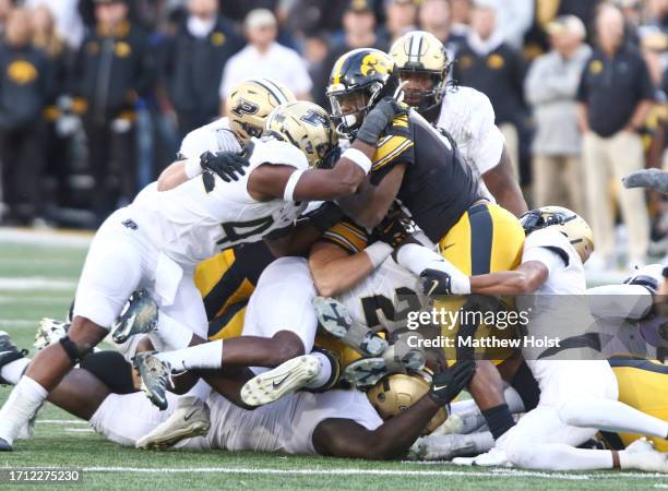 Running back Leshon Williams of the Iowa Hawkeyes is tackled during the second half against the Purdue Boilermakers at Kinnick Stadium on October 7,...