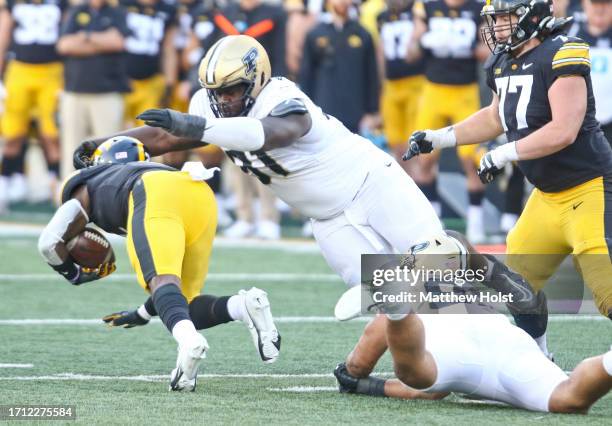 Defensive lineman Cole Brevard of the Purdue Boilermakers makes a tackle in the second half on running back Kaleb Johnson of the Iowa Hawkeyes at...