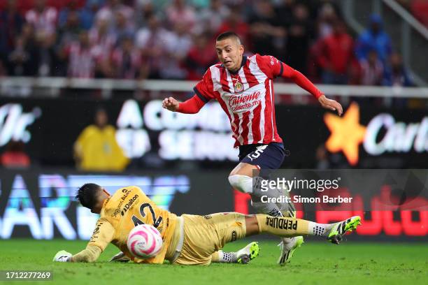 Roberto Alvarado of Chivas is fouled by Camilo Vargas of Atlas during the 12th round match between Chivas and Atlas as part of the Torneo Apertura...