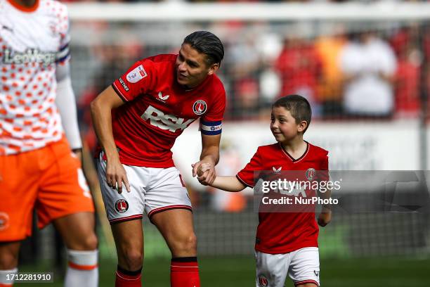 George Dobson of Charlton Athletic with a mascot during the Sky Bet League 1 match between Charlton Athletic and Blackpool at The Valley, London on...