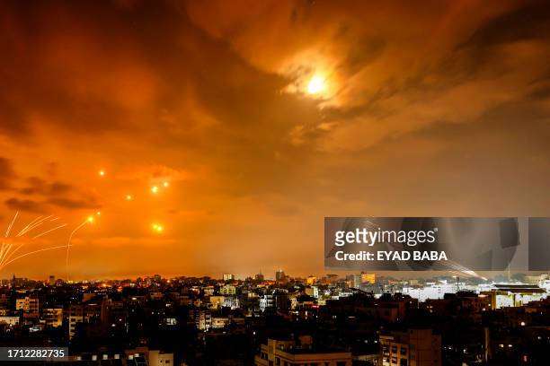 Rockets fired by Palestinian militants from Gaza City are intercepted by the Israeli Iron Dome defence missile system in the early hours of October...