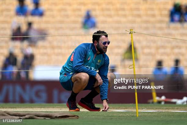 Australia's bowling coach Daniel Vettori inspects the pitch before the start of 2023 ICC Men's Cricket World Cup one-day international match between...
