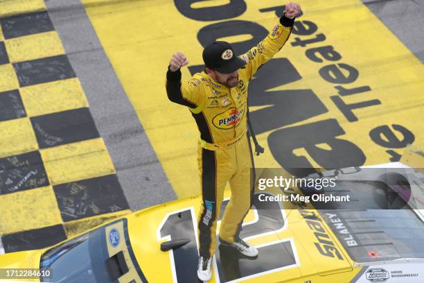 Ryan Blaney, driver of the Menards/Pennzoil Ford, celebrates after winning the NASCAR Cup Series YellaWood 500 at Talladega Superspeedway on October...