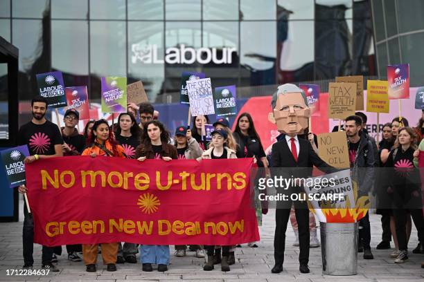 Young climate activists from the Green New Deal Rising campaign group hold a demonstration outside the venue on the first day of the annual Labour...