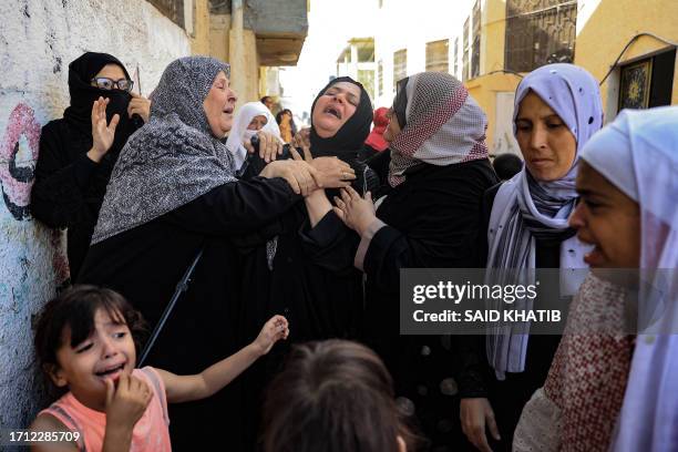 Women mourn during the funeral of members of the Abu Quta family who were killed in Israeli strikes on the Palestinian city of Rafah in the southern...