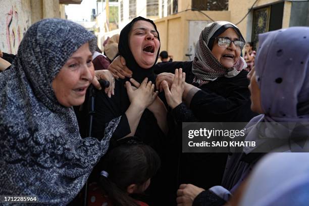 Women mourn during the funeral of members of the Abu Quta family who were killed in Israeli strikes on the Palestinian city of Rafah in the southern...