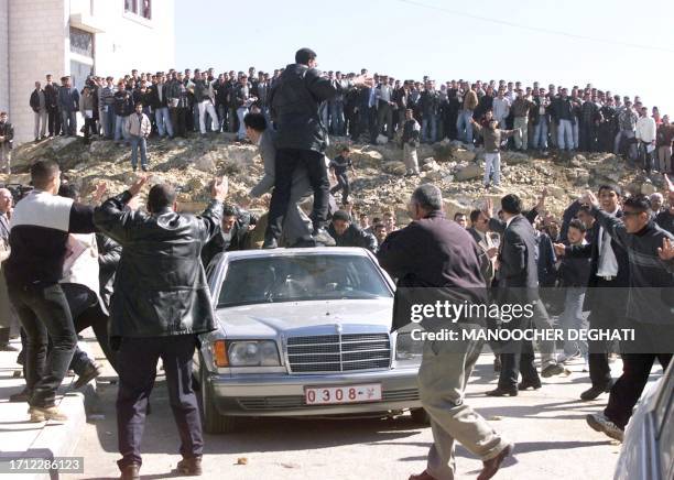 Palestinian security men stand on the car of French Prime Minister Lionel Jospin while Palestinian students watch in Bir Zeit university campus 26...