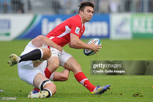 Jordan Williams of Wales is tackled during the 2013 IRB Junior World Championship Final match between England and Wales at Stade de la Rabine on June...