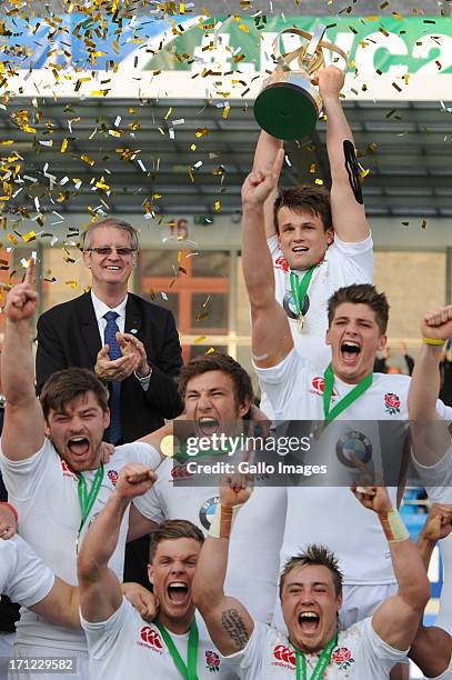 President of the IRB, Bernard Lapasset presents Captain Jack Clifford of England with the trophy during the 2013 IRB Junior World Championship Final...